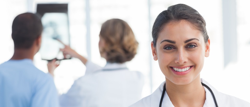 20s, Young Adult, Woman, Female, Caucasian, Man, Male, Mixed-Race, 40s, Mature Adult, Indoors, Looking At Camera, Nurse, Tunic, Practitioner, Profession, Professional, Specialist, Scrubs, Stethoscope, Standing, Clinic, Healthcare, Medical, Staff, Smiling, Happy, Cheerful, Portrait, Team, Talking, Holding, X-ray, Pointing, Hospital